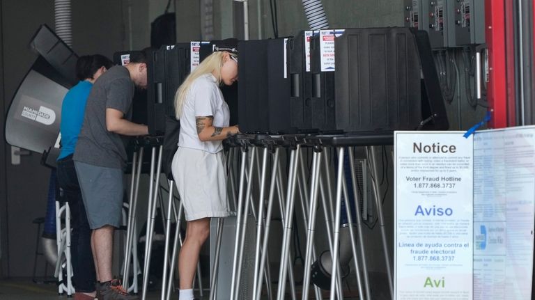 Voters cast their ballots in Florida's primary election, Tuesday, Aug....