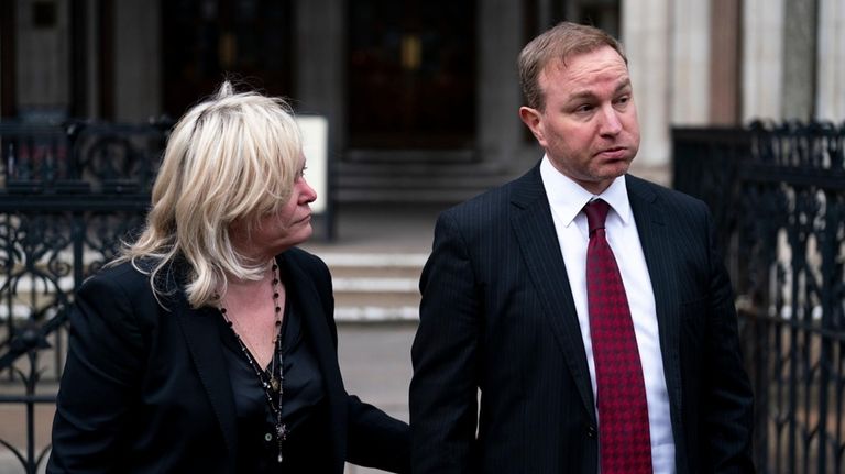 Financial market trader Tom Hayes walks with his lawyer Karen...