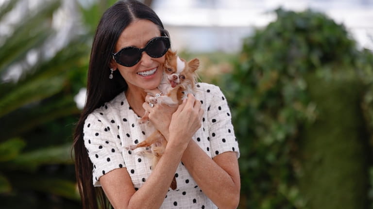 Demi Moore poses with her dog Pilaf for photographers at...