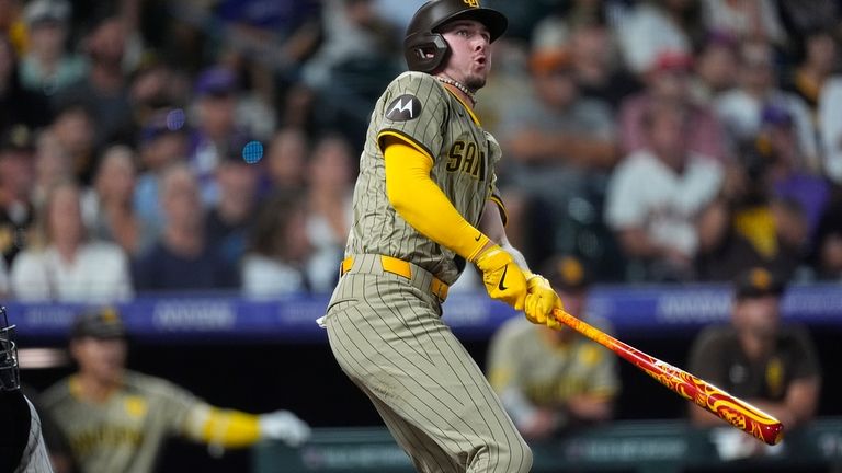 San Diego Padres' Jackson Merrill follows the flight of his...