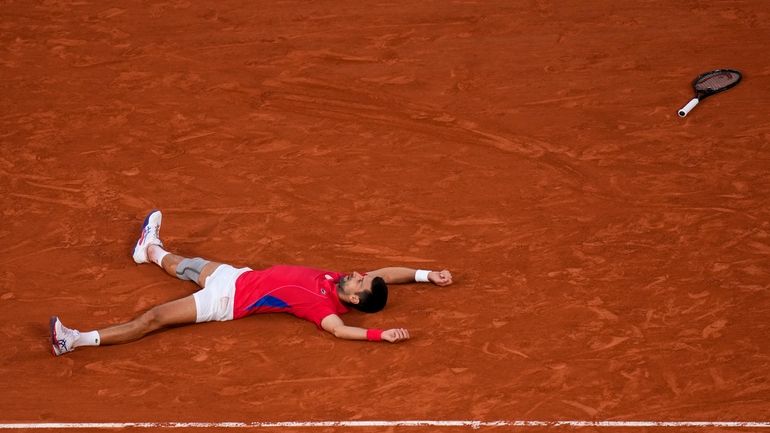 Novak Djokovic of Serbia celebrates after defeating Lorenzo Musetti of...