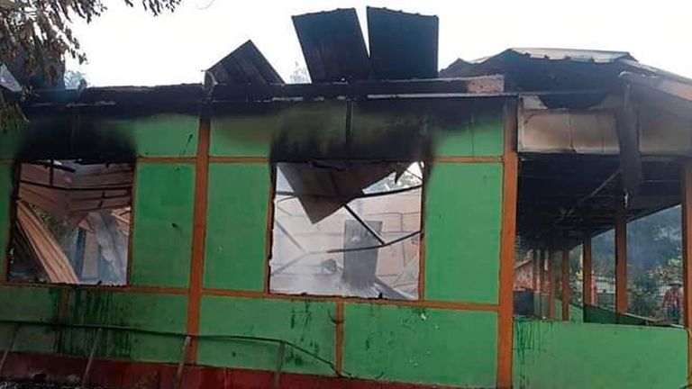 The wall of a school structure is left standing after...