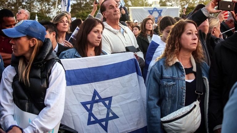 Missy Edelman of Syosett holds an Israeli flag during the rally...