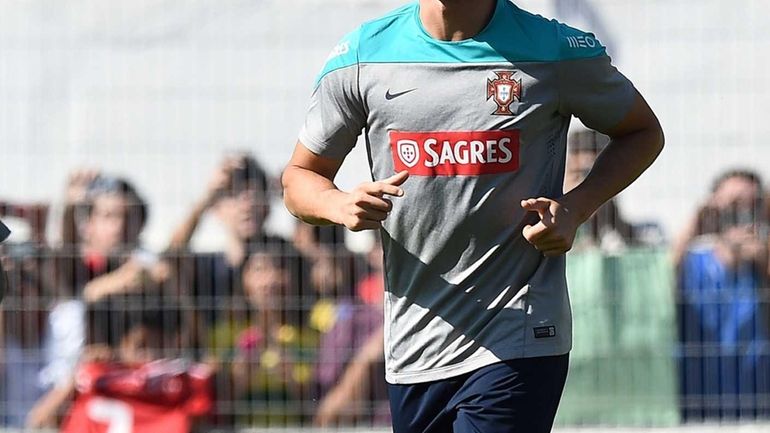 Portugal forward Cristiano Ronaldo runs during a training session in...