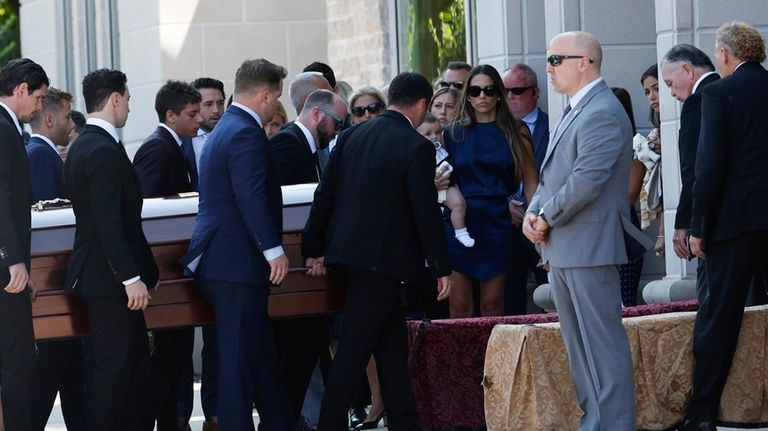 Pallbearers carry the casket of Columbus Blue Jackets hockey player...