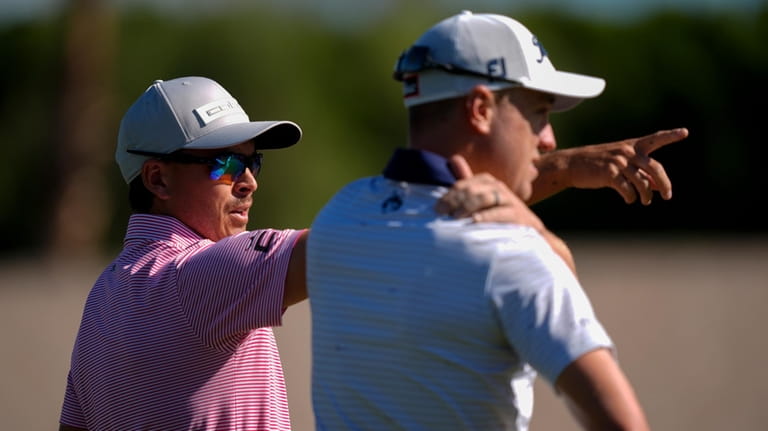 Rickie Fowler, left, points alongside Justin Thomas on the fifth...