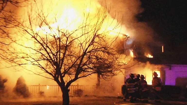 Setauket firefighters battle an early morning blaze at a house...