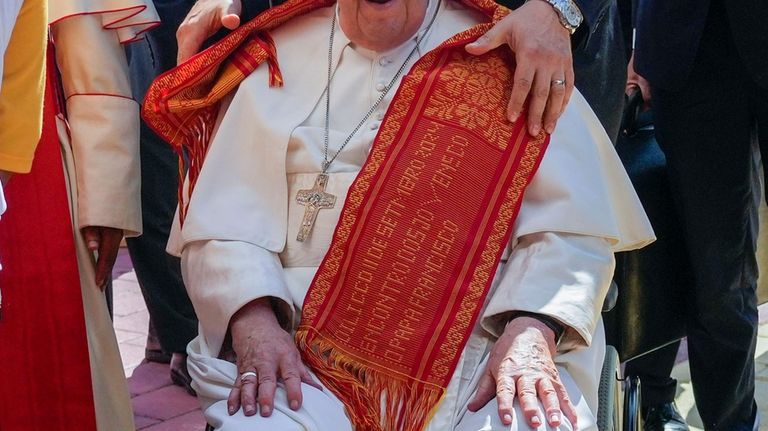 Pope Francis wears an East Timor traditional Tais scarf he...