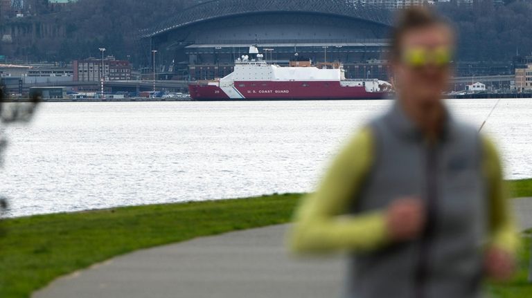 A person jogs along the Alki Trail as a U.S....