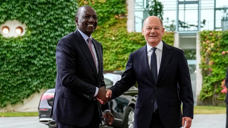 German Chancellor Olaf Scholz, right, welcomes Kenya's President William Ruto...