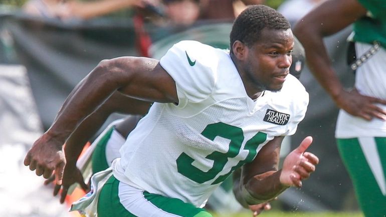 Jets running back Tarik Cohen performs a drill during training...