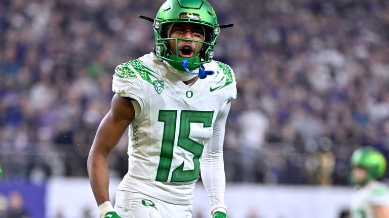 Oregon wide receiver Tez Johnson reacts after a touchdown against...