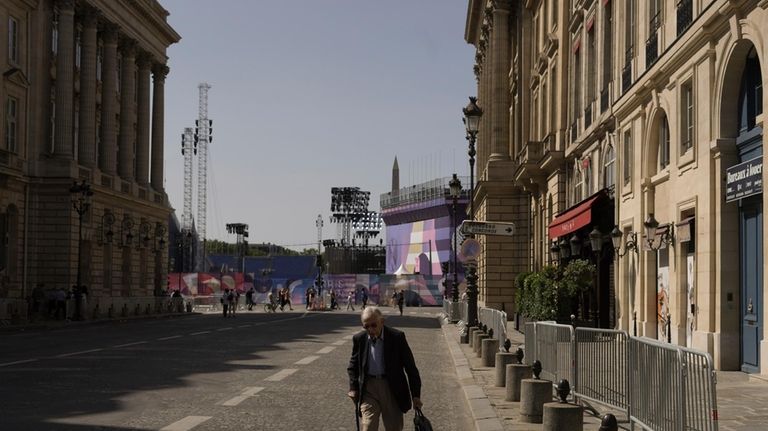 A man walks next to the Place de la Concorde,...