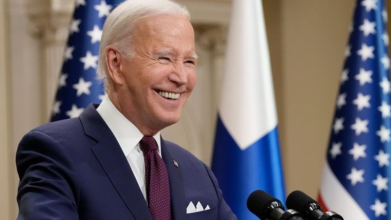 President Joe Biden smiles during a news conference with Finland's...