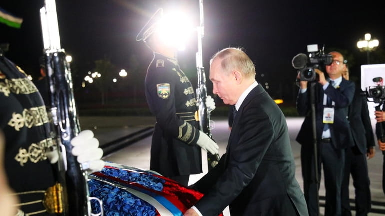 Russian President Vladimir Putin takes part in a wreath-laying ceremony...