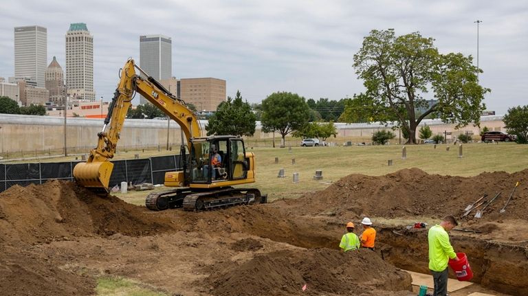 Researchers work in Oaklawn Cemetery as they search for victims...