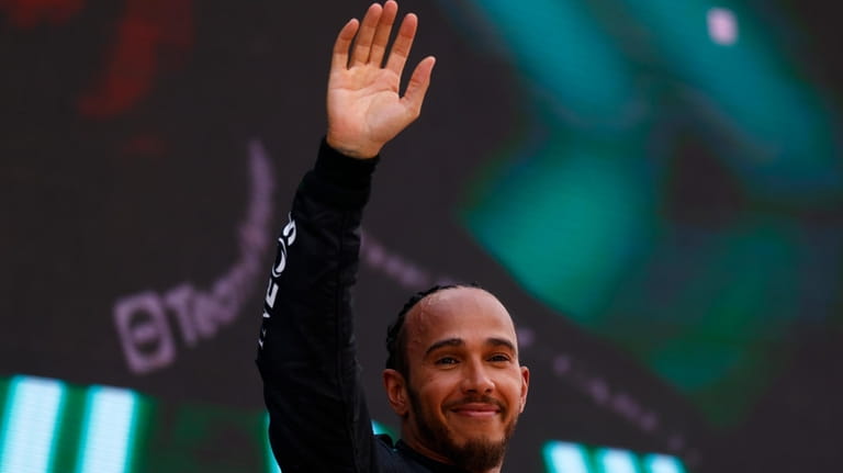 Mercedes driver Lewis Hamilton of Britain celebrates his third position...