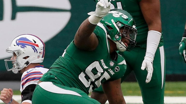 Quinnen Williams of the Jets reacts after sacking Josh Allen...
