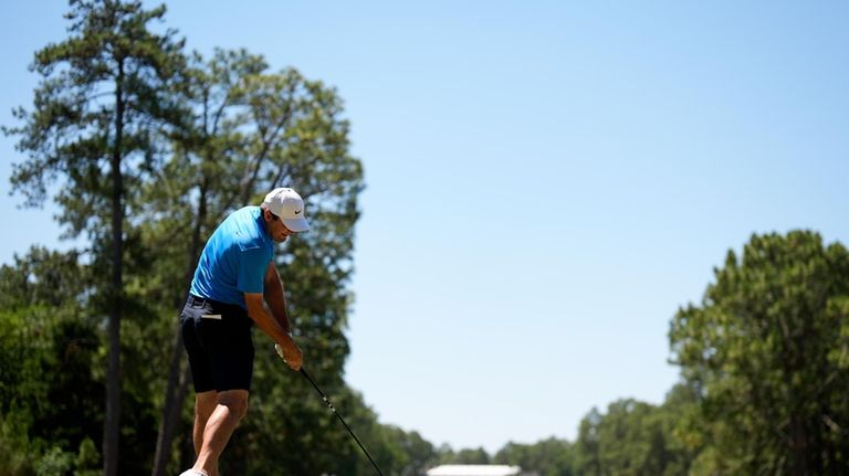 Scottie Scheffler hits his tee shot on the 10th hole...