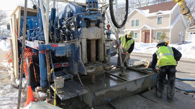 Northrop Grumman contractors drill at the corner of William Street...