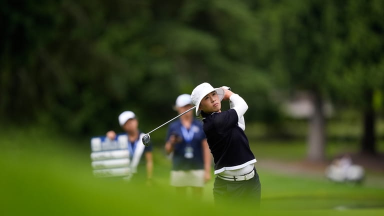 Amy Yang, of South Korea, hits from the 18th fairway...