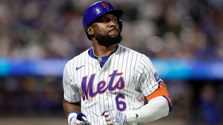 Starling Marte of the Mets looks on after flying out during...