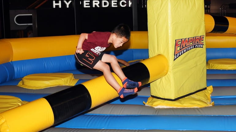 Eason Zhang 6, of East Meadow, tries to out-jump a...