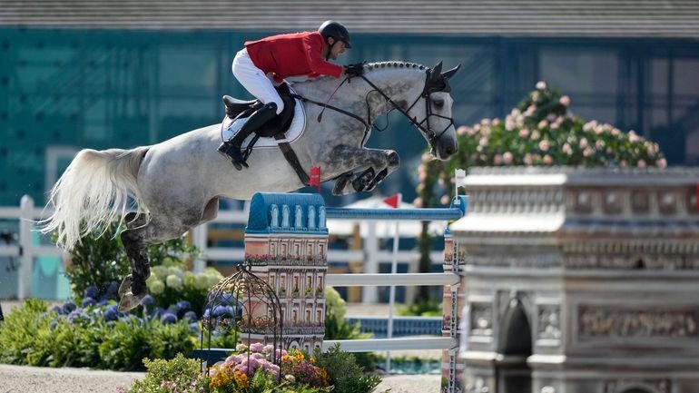 Germany's Christian Kukuk rides Checker 47 during the Jumping Individual...