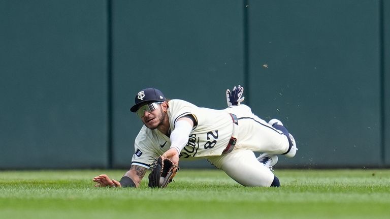 Minnesota Twins center fielder Austin Martin dives to catch a...