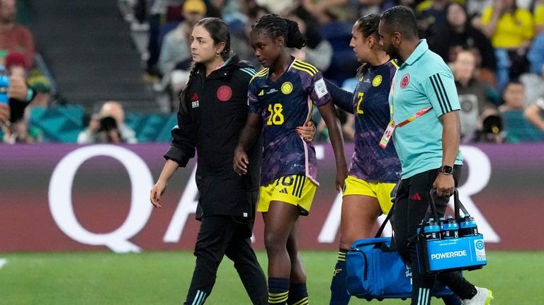 Colombia's Manuela Vanegas, center right, speaks to teammate Linda Caicedo...