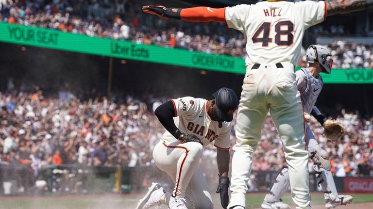 San Francisco Giants' Jorge Soler and Derek Hill (48) celebrate...