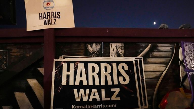 Signs for Kamala Harris and Tim Walz are posted in...