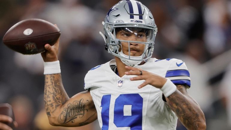 Dallas Cowboys quarterback Trey Lance warms up before an NFL...