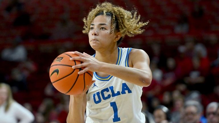 UCLA guard Kiki Rice (1) shoots a three point shot...