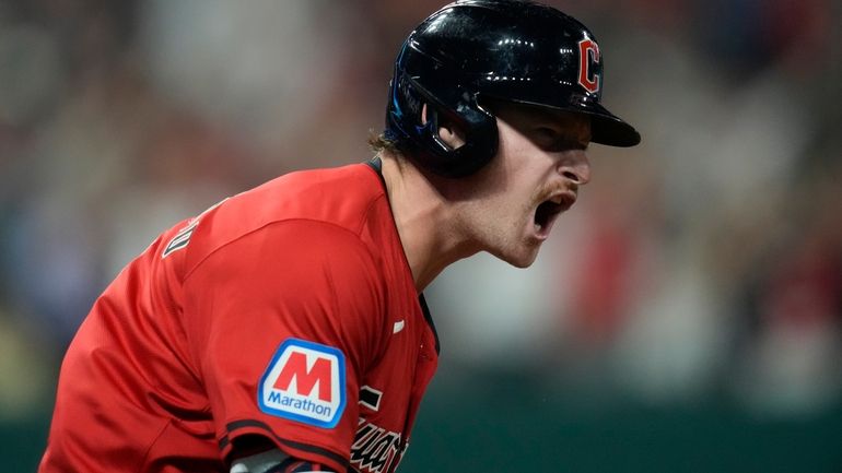 Cleveland Guardians' Kyle Manzardo reacts as he runs the bases...