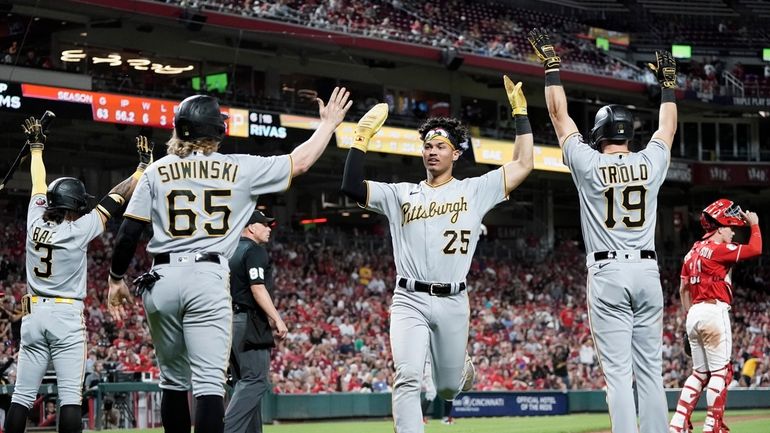 Pittsburgh Pirates' Endy Rodriguez, center, celebrates with Jack Suwinski (65)...