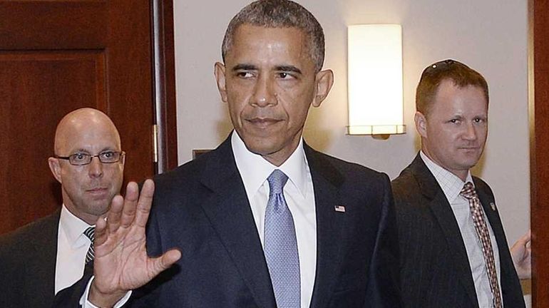 President Barack Obama and House Minority Leader Nancy Pelosi leave...