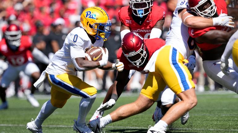 Pittsburgh running back Desmond Reid (0) carries the ball during...