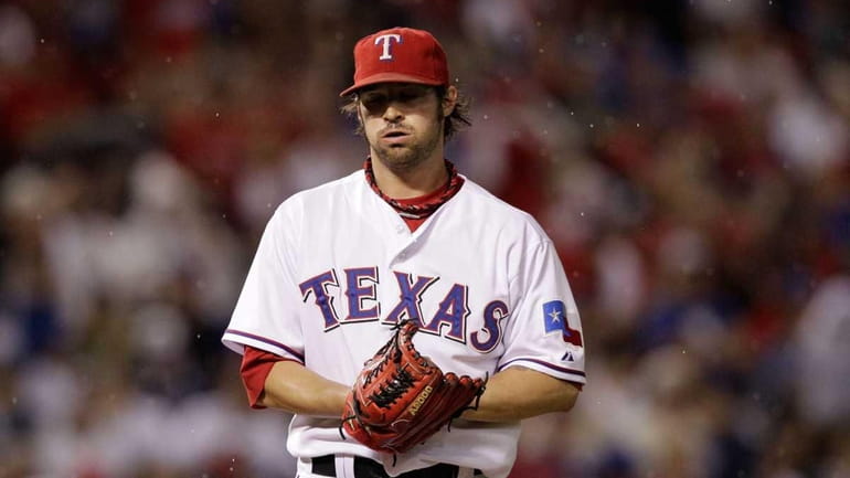 C.J. Wilson #36 of the Texas Rangers reacts against the...