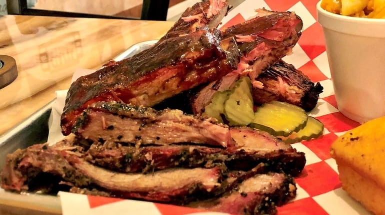 Ribs and brisket are two of the smoked specialties at...