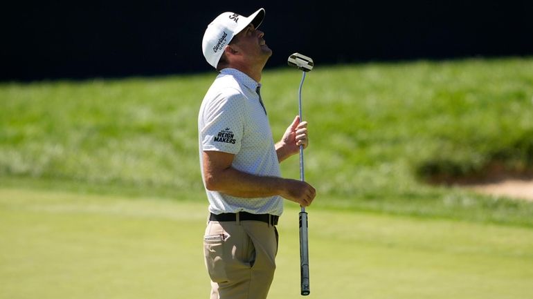 Keegan Bradley looks upward after his shot on the 14th...