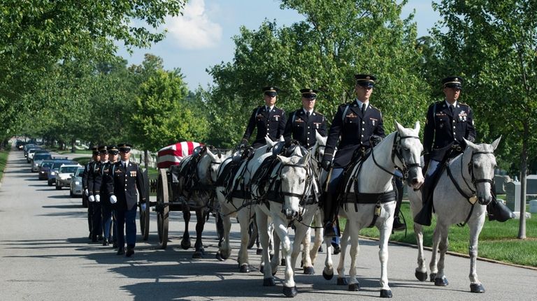 A U.S. Army Caisson team carries the casket of Army...