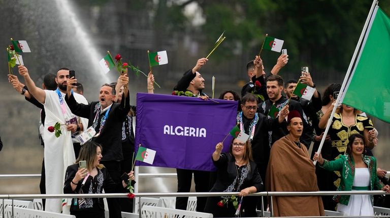 Team Algeria wave flags in Paris, France, during the opening...