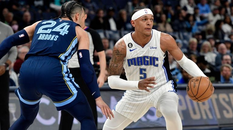 Orlando Magic forward Paolo Banchero (5) handles the ball against...