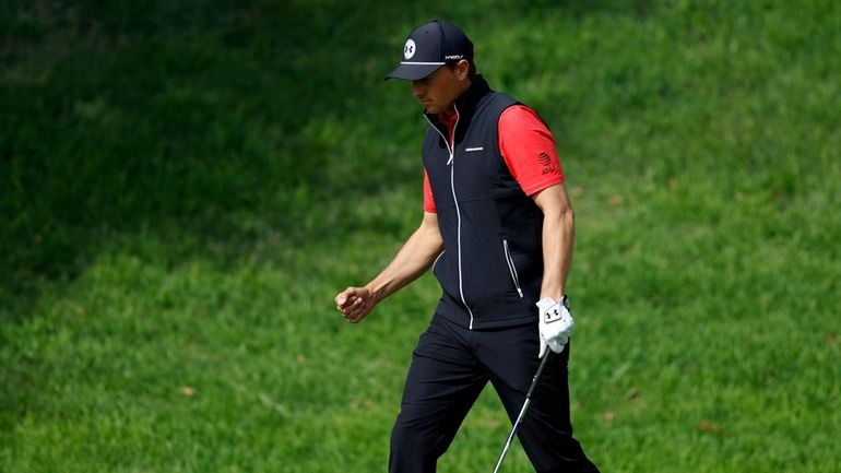 Jordan Spieth reacts after chipping in for birdie on the...