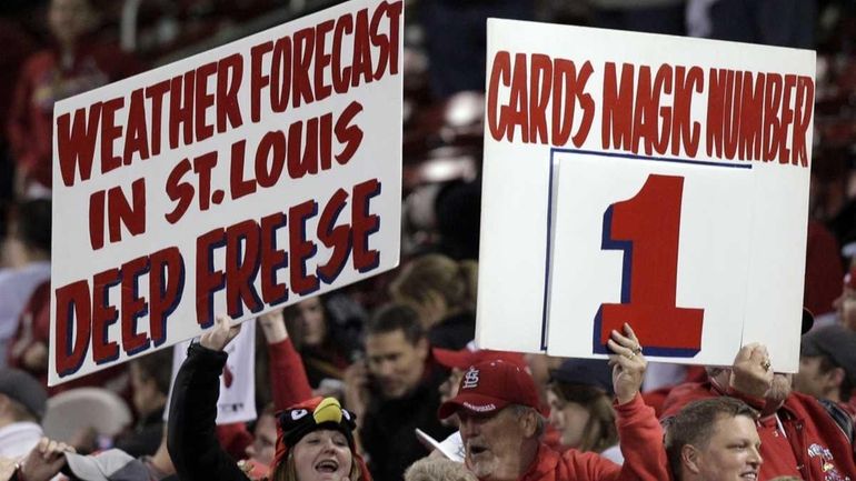 Fans cheer after the 11th inning of Game 6 of...