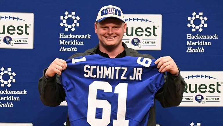 New York Giants first round draft pick Deonte Banks holds up a Giants  jersey during a press conference at the NFL football team's training center  in East Rutherford, N.J., Friday, April 28