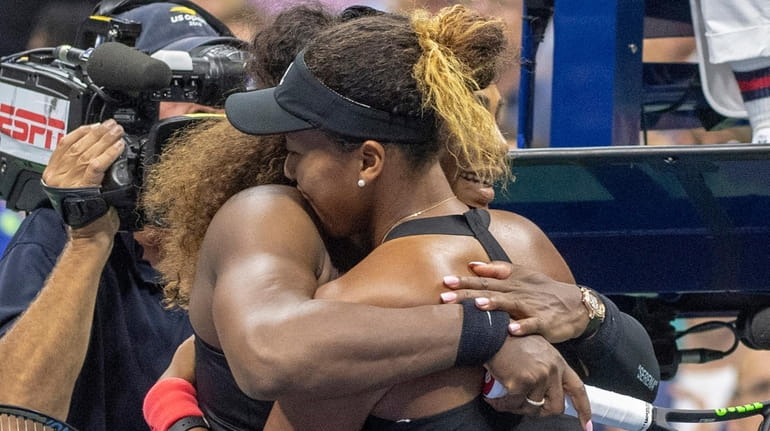 Serena Williams hugs Naomi Osaka after Osaka won the U.S....