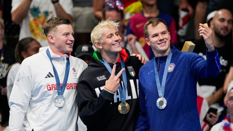 Gold medalist, Nicolo Martinenghi, center, of Italy, stands with silver...