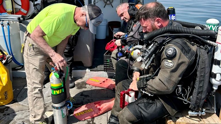 A team prepares on Friday to dive the wreck of...